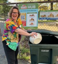 photo of person dropping off food scraps at a we compost community hub
