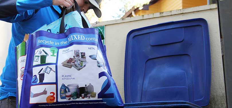 resident with recycling bag at apartment